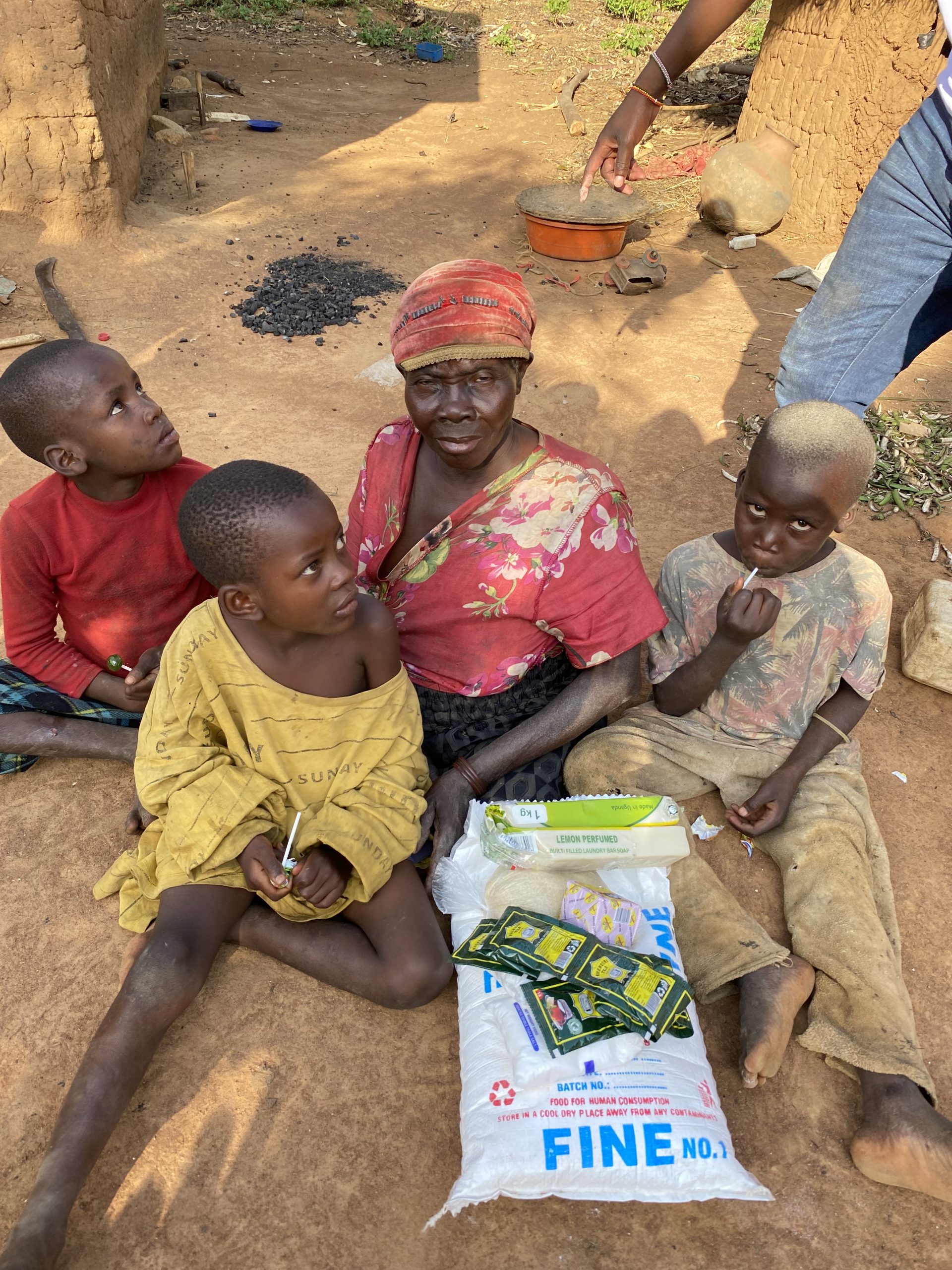 Elderly woman receiving food assistance through Mission of Hope Uganda.