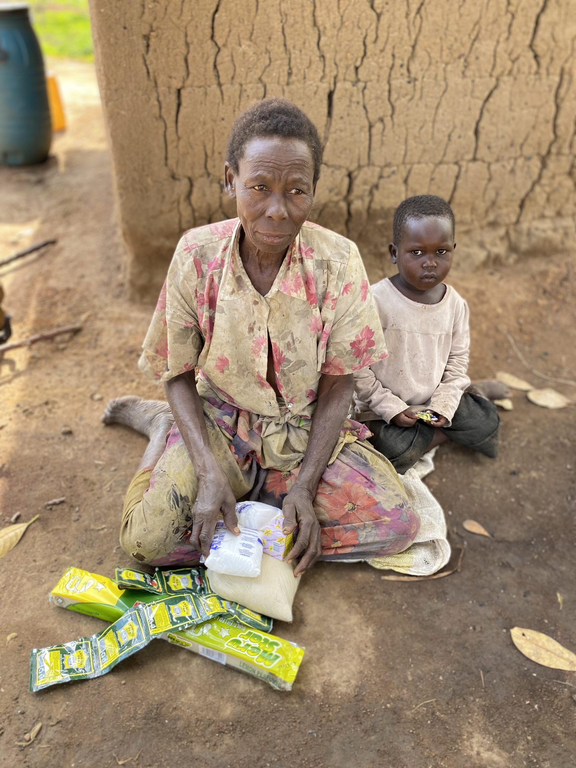 Elderly woman receiving food assistance through Mission of Hope Uganda.