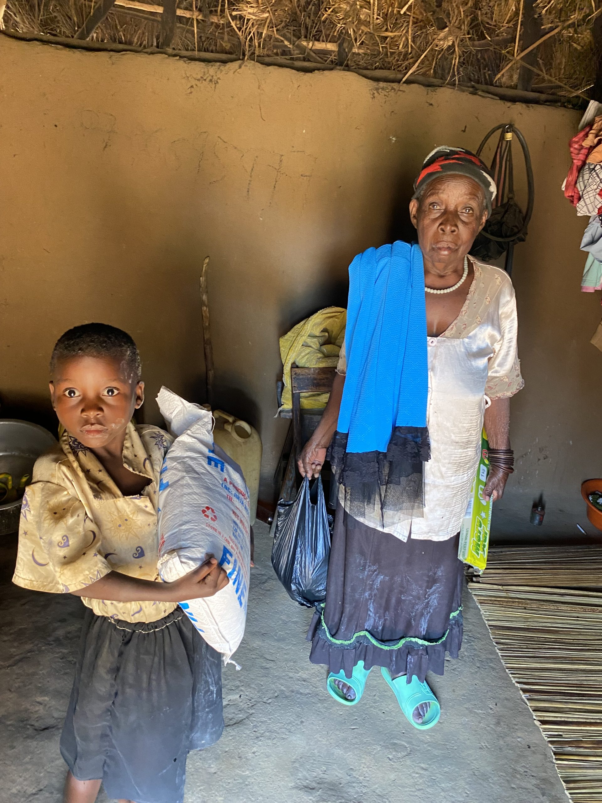 Elderly woman receiving food assistance through Mission of Hope Uganda.