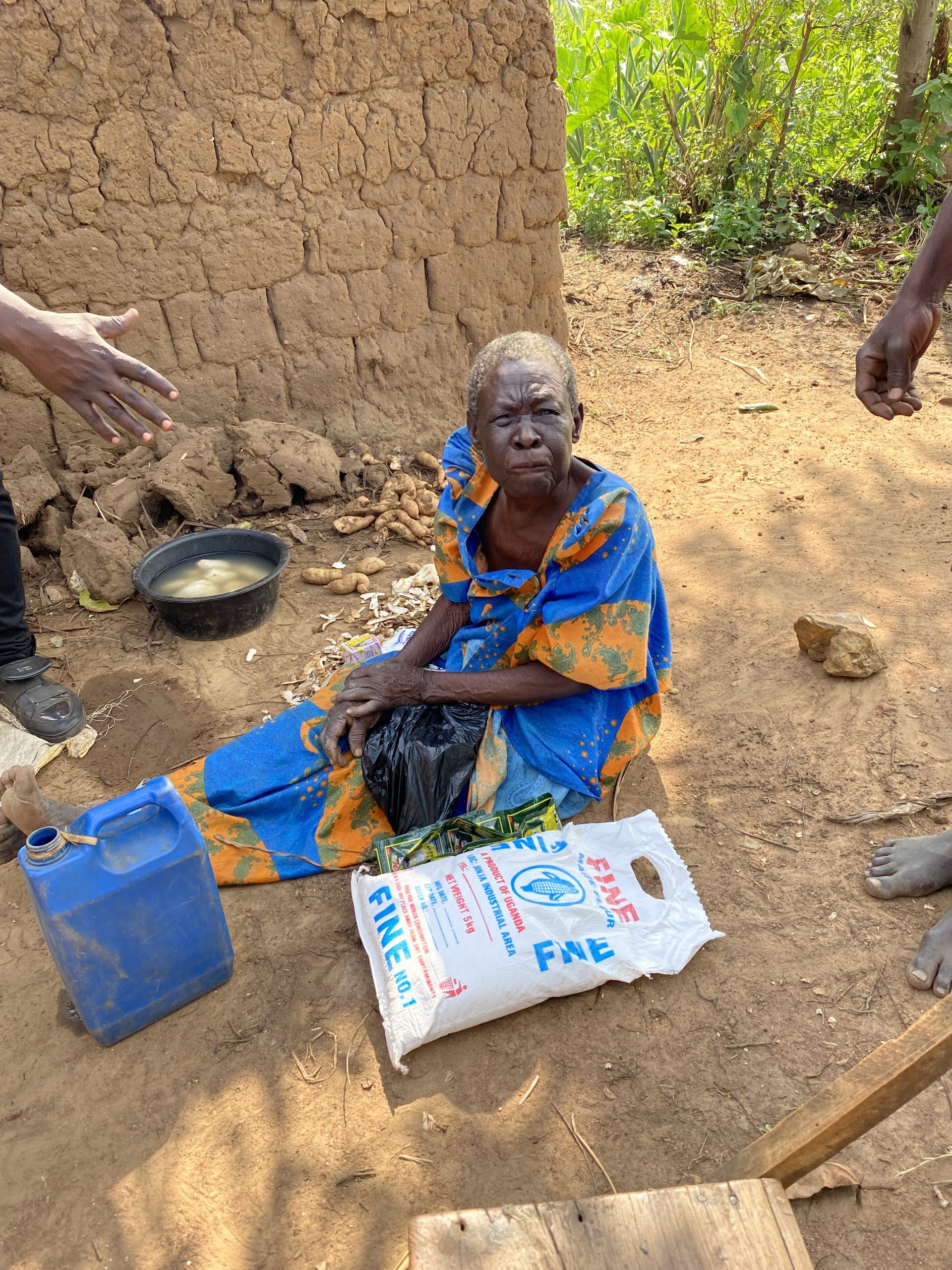 Elderly woman receiving food assistance through Mission of Hope Uganda.
