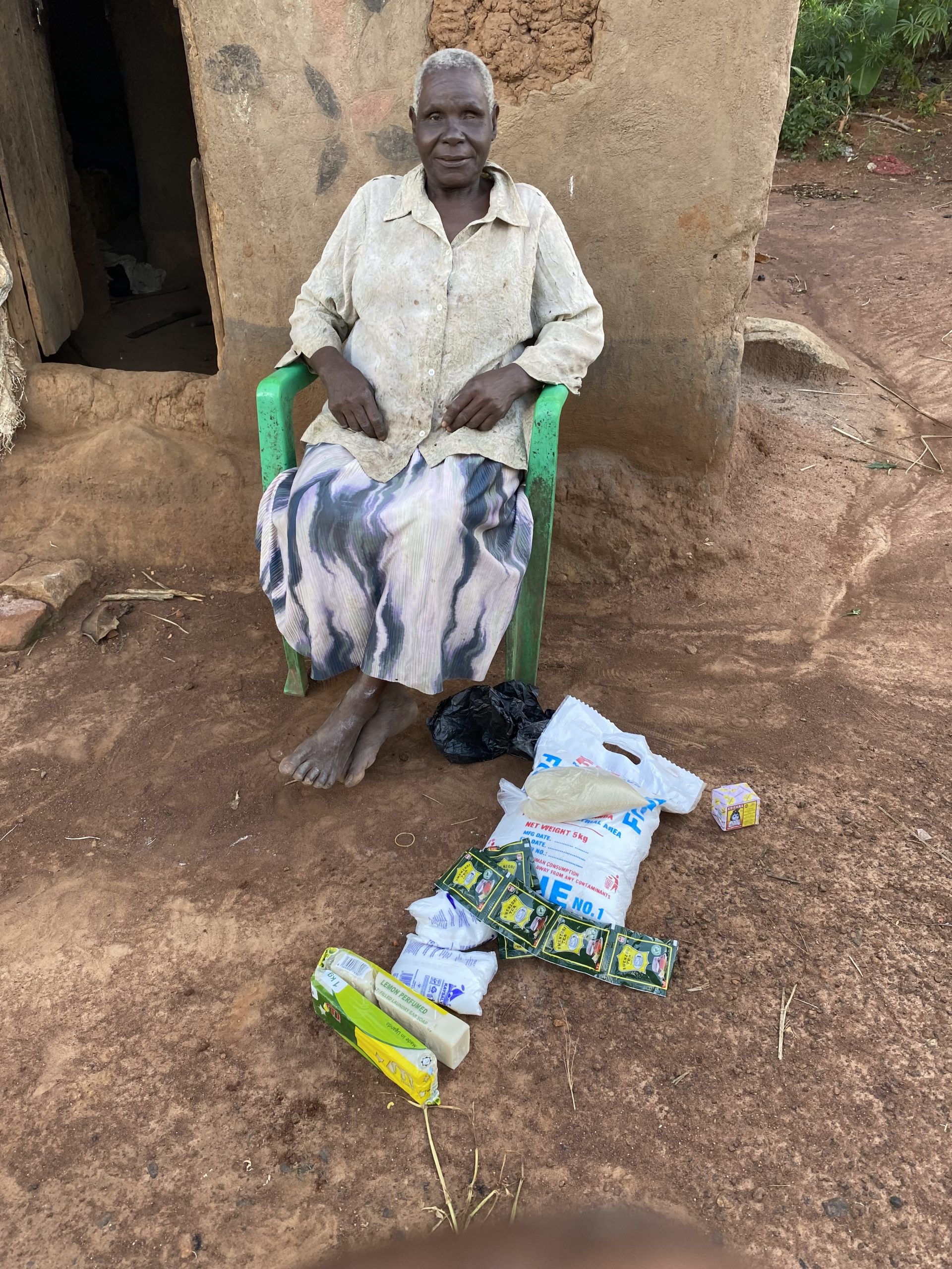 Elderly woman receiving food assistance through Mission of Hope Uganda.
