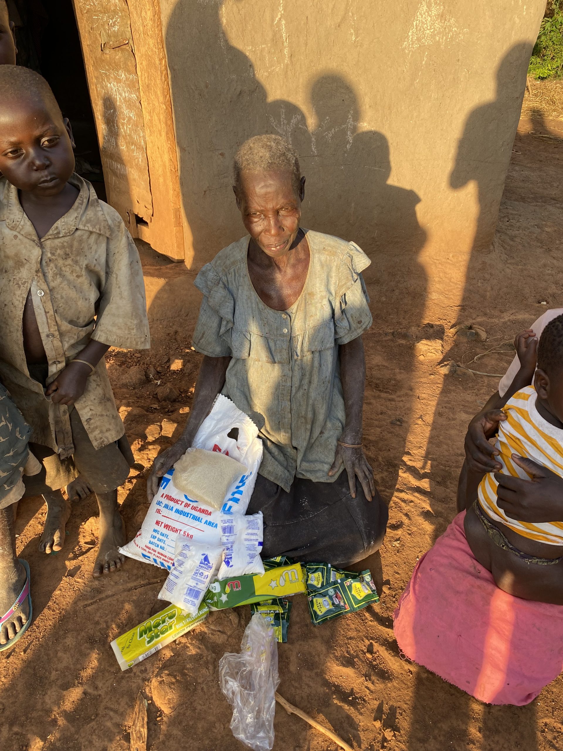 Elderly woman receiving food assistance through Mission of Hope Uganda.